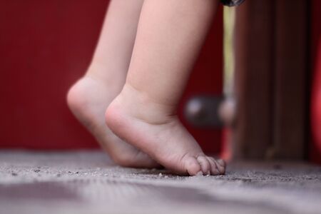 Toddler abou 2 years old standing up on his toesの写真素材