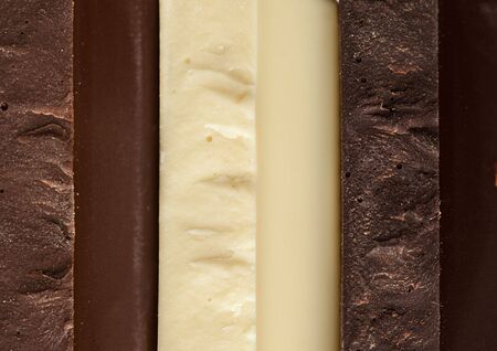 Stack of Black, Brown and White Chocolate isolated on white background