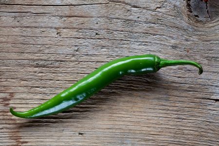 Fresh Green Chili Pepper on wooden board