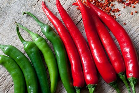 Fresh Red and Green Chili Pepper on wooden board