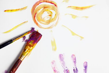 Child fingerpainting in vivid colorsの写真素材
