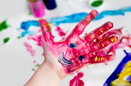 Little Children Hands doing Fingerpainting with vivid colorsの写真素材