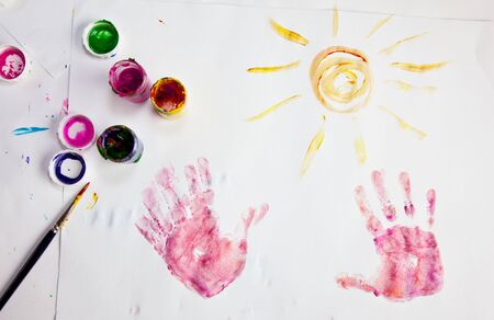 Child fingerpainting in vivid colorsの写真素材
