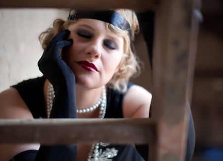 Vintage retro portrait of a woman costumed in 1920s styleの写真素材