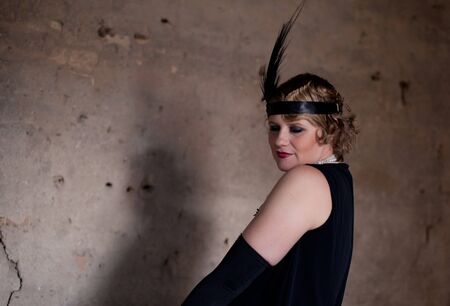 Vintage retro portrait of a woman costumed in 1920s styleの写真素材
