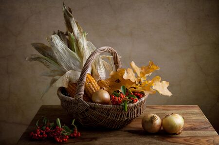 Still Life Autumn concept image with vegetables and wicker basket