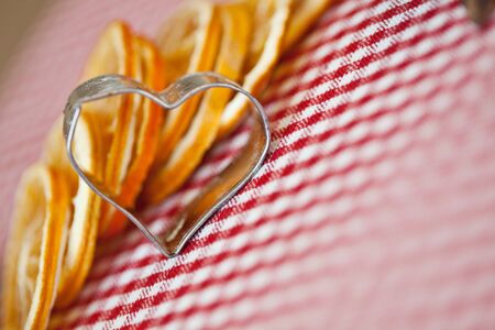 Dried Orange and  cookie cutter on chequered clothの写真素材