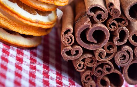 Dried Orange and Cinnamon Sticks on chequered clothの写真素材