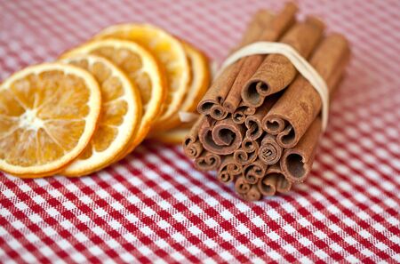 Dried Orange and Cinnamon Sticks on chequered clothの写真素材