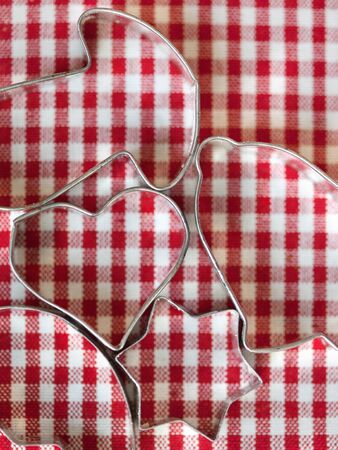 Cookie Cutters for christmas bakery on chequered clothの写真素材