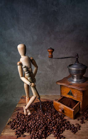 Still Life with Coffee grinder and jointed doll working the millの写真素材