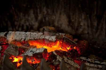 Glowing embers from burned down fire in fireplaceの写真素材