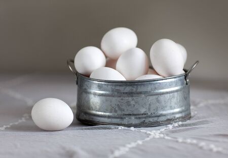 Still Life with heap of fesh white eggs in metal bowlの写真素材