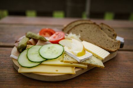 Jause with bread, ham and cheese served in an alpine chalet in Austriaの写真素材