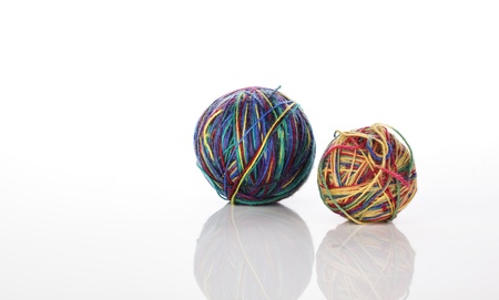 Two balls of wool in multiple colors on whiteの写真素材