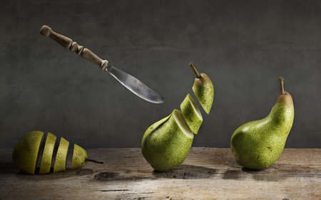 Fresh Pears being chased and cut to slices by flying knifeの写真素材