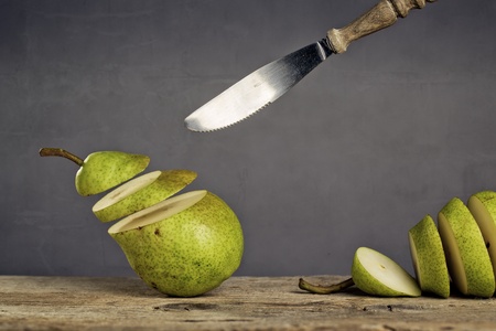 Fresh Pears being chased and cut to slices by flying knifeの写真素材