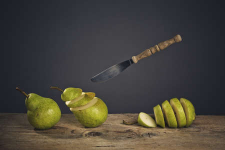 Fresh Pears being chased and cut to slices by flying knifeの写真素材