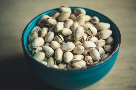 Still-Life with roasted and salted Pistachios served as a snack in bowl の写真素材