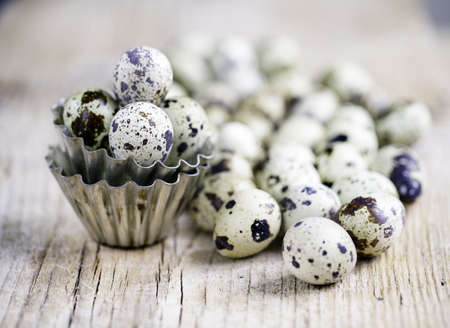Quail Eggs with small metal baking forms on table