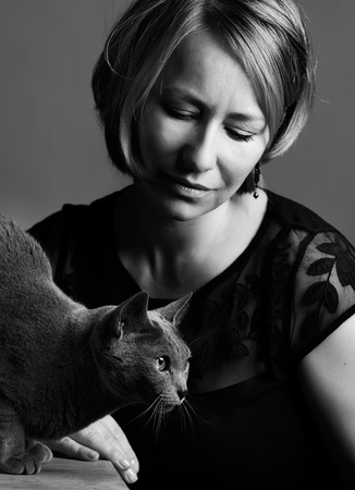 Portrait of an adult Woman with her purebred Russian Blue Catの写真素材