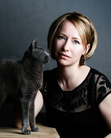 Portrait of an adult Woman with her purebred Russian Blue Catの写真素材