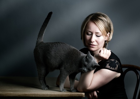 Portrait of an adult Woman with her purebred Russian Blue Catの写真素材