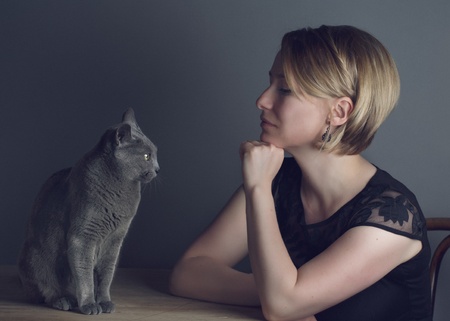 Portrait of an adult Woman with her purebred Russian Blue Catの写真素材
