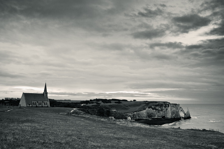 Cliffs at Etretat with the Chapel Notre-Dame-de-la-Garde in the Evening in Autumnの写真素材