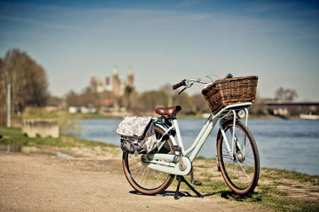 Retro Bike standing in Front of the View of the medieval romanic Cathedral and the River Rhine at Speyer Germanyの写真素材