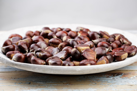 Plate with fresh Sweet Chestnuts from the Forest in Autumnの写真素材