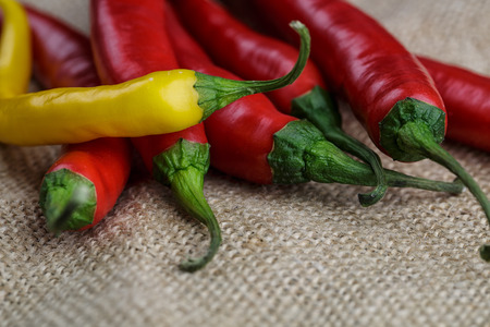 Red and Yellow Chili Peppers on Linen Clothの写真素材