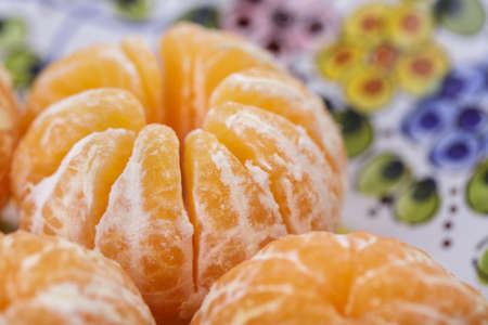 Fresh Peeled Clementines on Stoneware Plateの写真素材