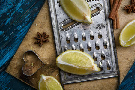 Fresh Lemon with metal grater on blue boardの写真素材