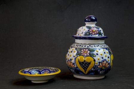 A beautiful vase of talavera on a black background with his plate partner coming to the partyのeditorial素材