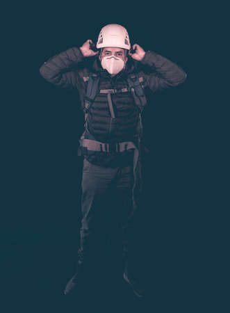 full length portrait of hiker with mask and helmet on blue backgroundの写真素材