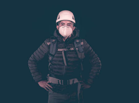 full length portrait of hiker with mask and helmet on blue backgroundの写真素材