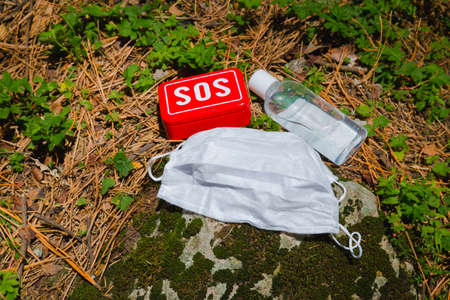 antibacterial gel, medical mask and sos aid tools in the forest