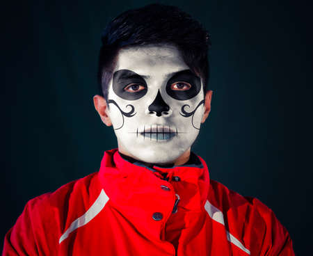 portrait of a young man with a mexican calaveras makeupの写真素材
