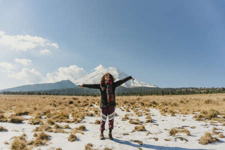 Woman enjoys the trail with views of the volcano of popocatepetl, mexicoの写真素材