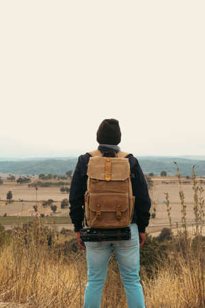 Back view of unknown man looking the valley view