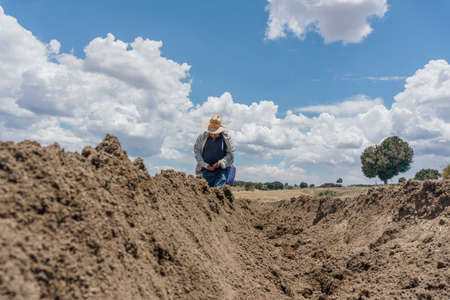 a mexican farmer planting corn panoramic viewの写真素材