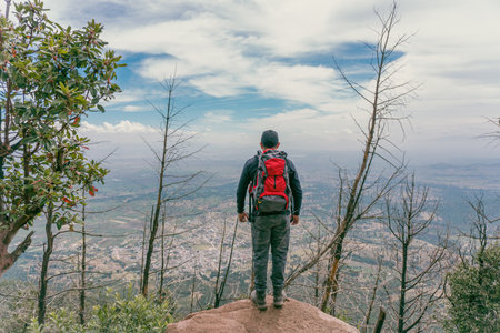 Young backpacking man traveler enjoying mountains. Travel and active lifestyle conceptの写真素材