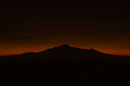 Panoramic view of mountains, autumn landscape with foggy hills at sunriseの写真素材