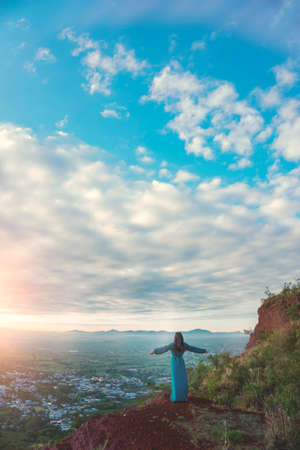 Woman with open arms at dawnの写真素材