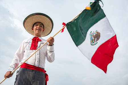 Young boy holding flag of Mexicoの写真素材