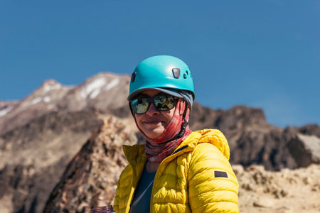 Portrait of a smiling woman relaxing during a mountain hikeの写真素材