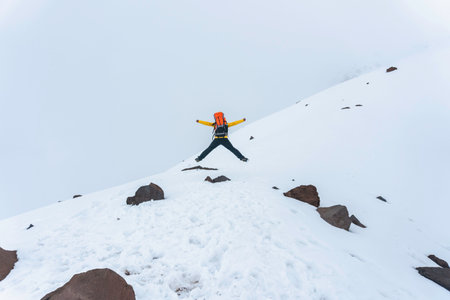 A hiker man jumping on the base of chimborazo Mountain in ecuador