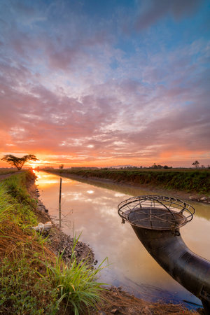 Beautiful sunrise at canal with colorful skyの写真素材