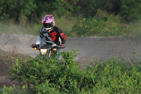 Rayong ,Thailand - JUNE 20, 2020 : Thai Motocross racer accelerating in dirt trackl. in practice motocross field at Thailand.のeditorial素材